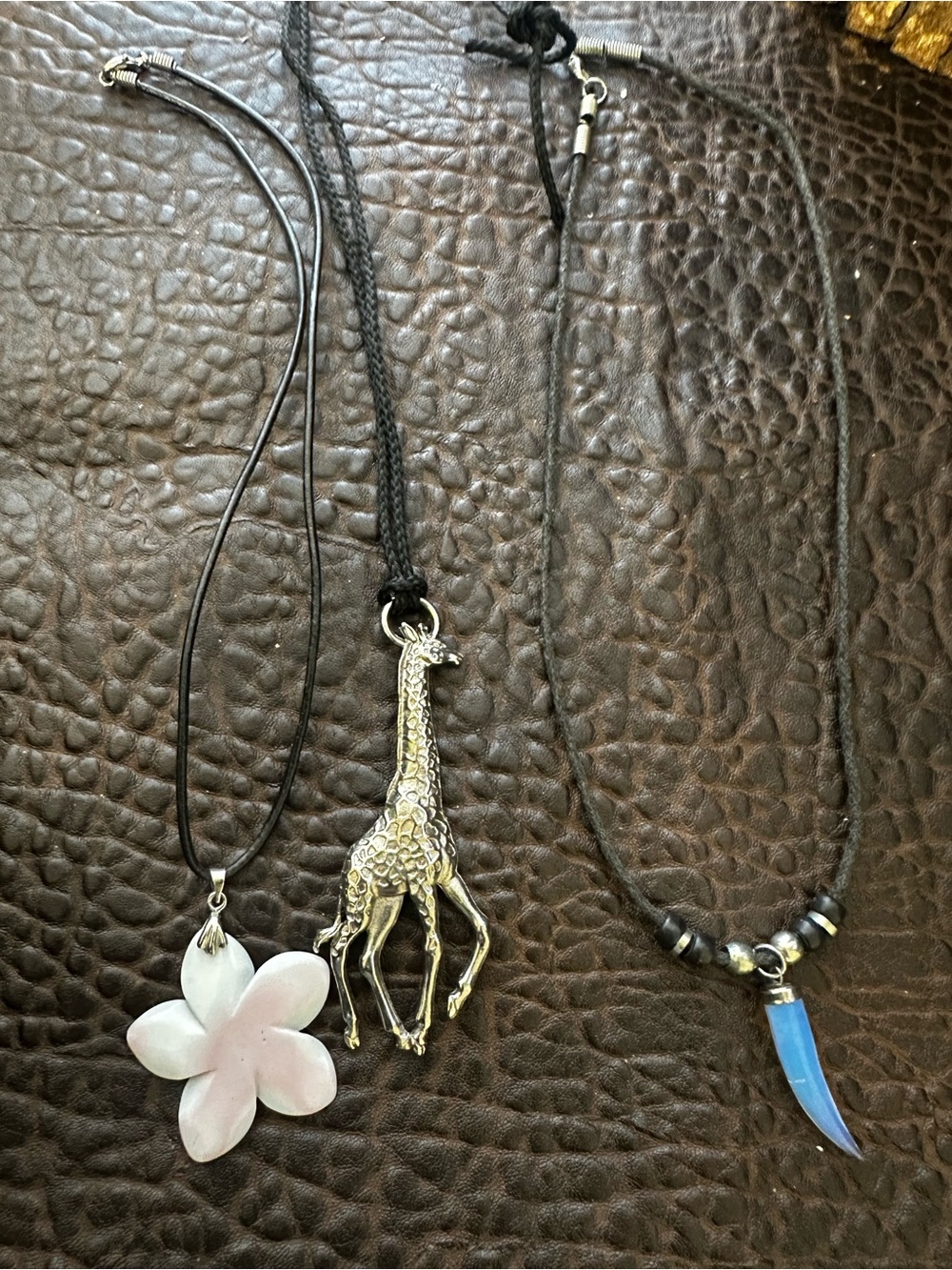 Lot of three neckless giraffes, flower and tusk